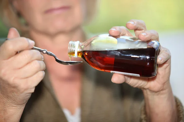 Woman taking cough medicine — Stock Photo, Image