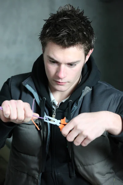 Young electrician using pliers — Stock Photo, Image