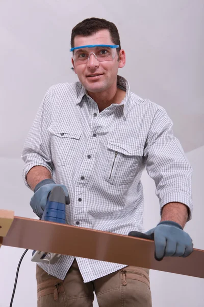 Man cutting a floorboard — Stock Photo, Image
