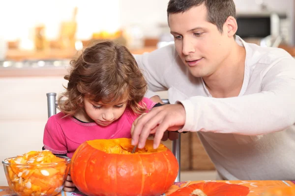 Father and daughter preparing pumpkin Stock Image