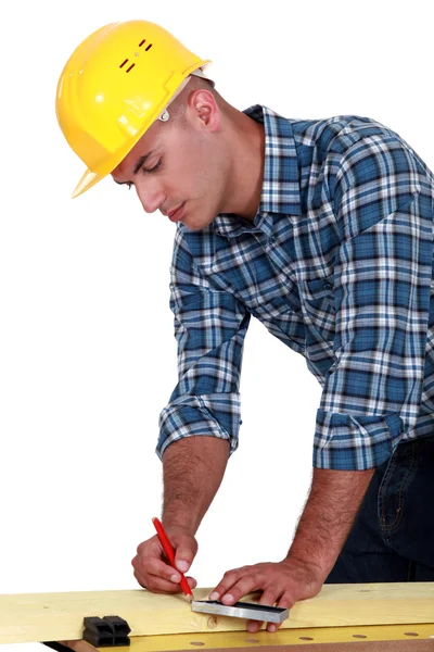 A carpenter taking measures. Royalty Free Stock Images