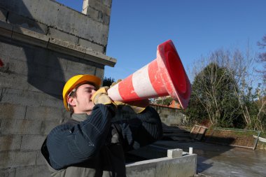 Man shouting through traffic cone clipart