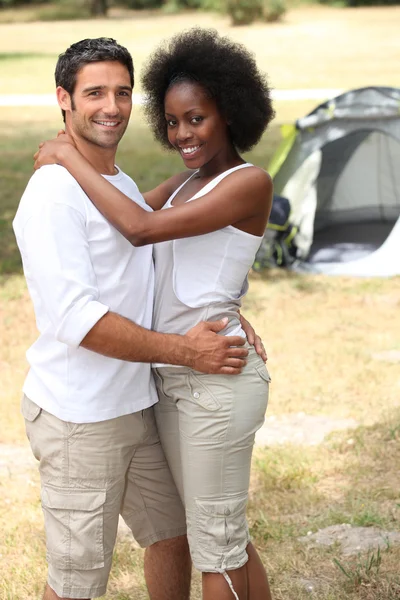 Loving couple hugging in front of their tent — Stock Photo, Image