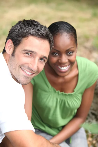Mixed-race couple at the park — Stock Photo, Image