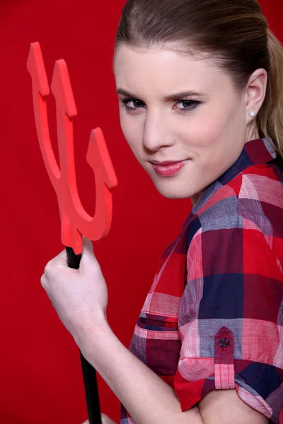 A cute woman holding the evil pitchfork. — Stock Photo, Image