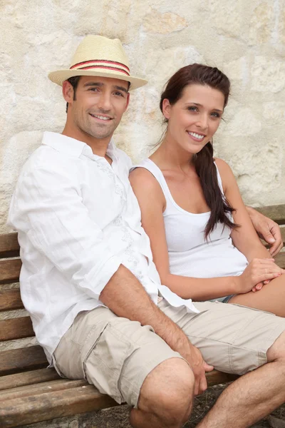 Couple sat on bench Stock Image