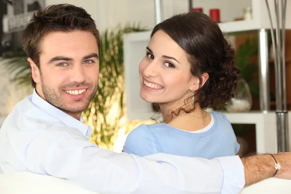 Smiling couple sitting on Royalty Free Stock Images