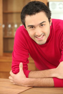 A smiling man in a kitchen clipart