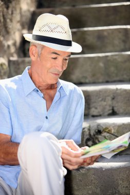 Old man reading magazine clipart