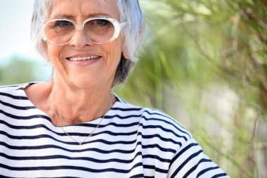 Elderly lady at the beach clipart