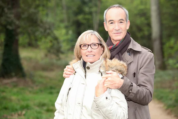 Older couple in a forest — Stock Photo, Image