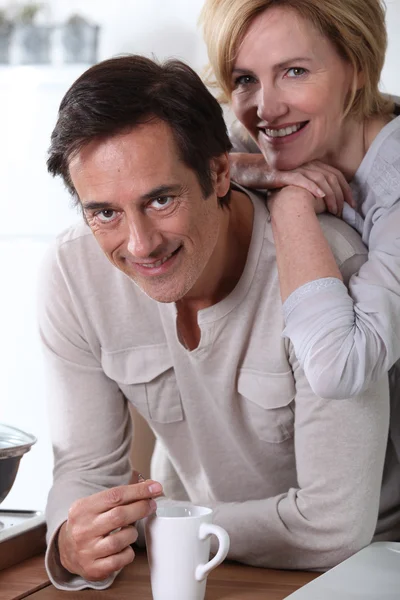 Hombre bebiendo café en la cocina con esposa —  Fotos de Stock