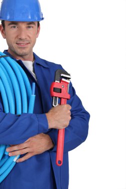 Closeup of an electrician with roll of blue cable and a wrench clipart