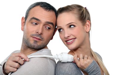 Couple stood back-to-back holding electrical cable clipart