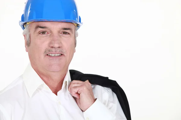 Senior businessman wearing helmet and smiling — Stock Photo, Image