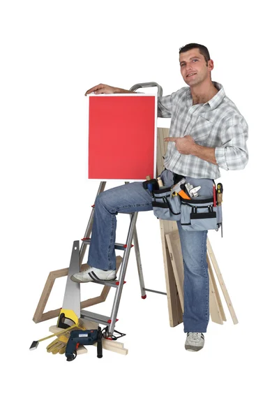 Carpenter proudly standing by equipment — Stock Photo, Image