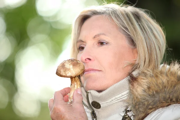 Donna che annusa un fungo — Foto Stock