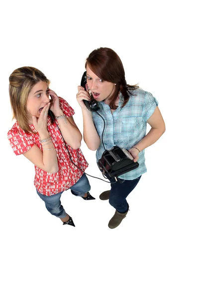 Girls gossiping on the phone — Stock Photo, Image