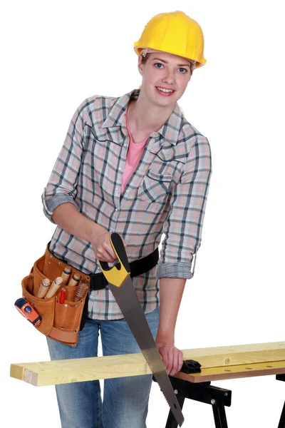 Young female carpenter using saw — Stock Photo, Image