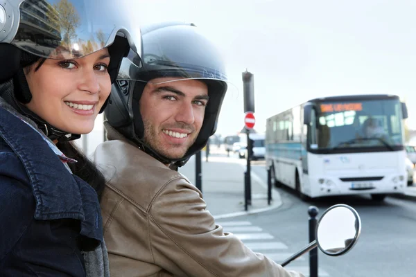 Couple on scooter in a crossroad — Stock Photo, Image
