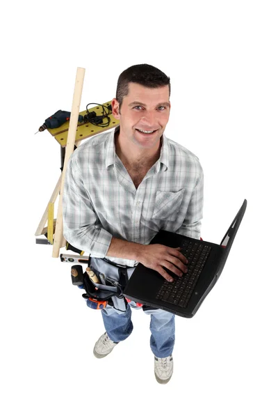 Top-view of carpenter with laptop — Stock Photo, Image