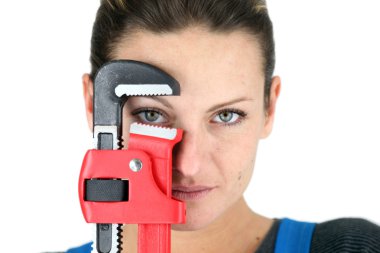 The jaw of a pipe wrench framing a woman's eye clipart