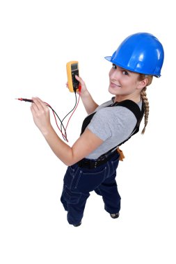 Female electrician with a voltmeter clipart