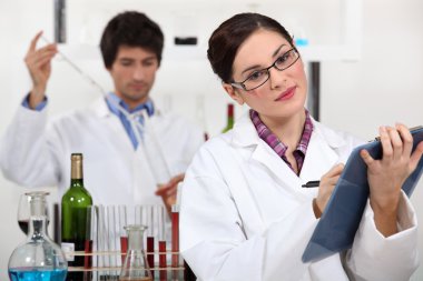 Oenologists analysing a wine clipart