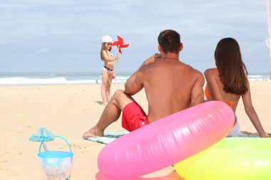 Family at the beach together clipart