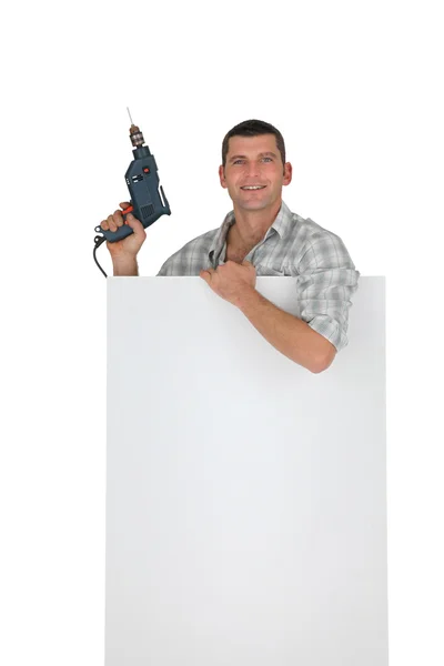 Handyman behind white board — Stock Photo, Image