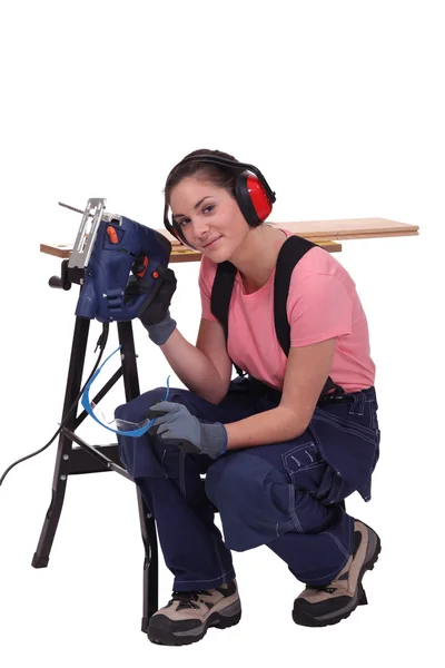 Woman with an electric saw — Stock Photo, Image