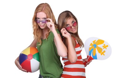 Studio shot of teenage girls with beachballs clipart