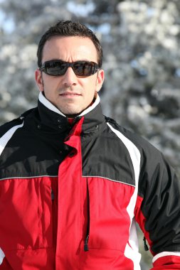 Man in a ski jacket and sunglasses clipart