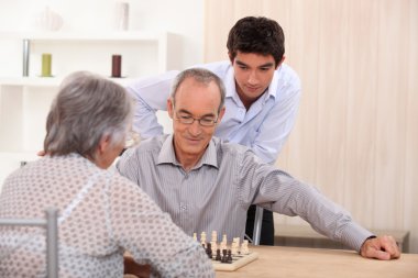 Senior couple playing chess clipart