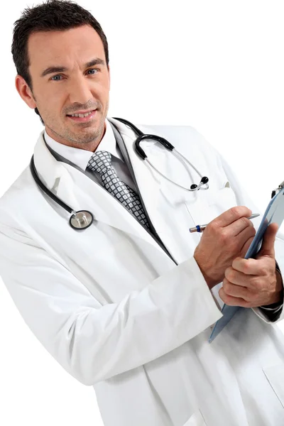 Läkare skriver på skrivbordet leende — Stockfoto