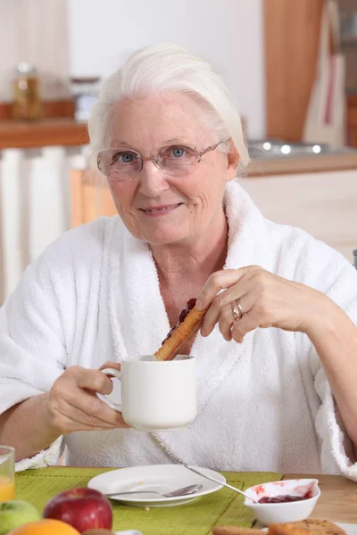 Grandmother having breakfast — Stock Photo, Image
