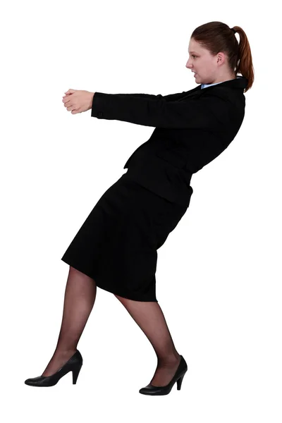 Businesswoman pulling an invisible object — Stock Photo, Image