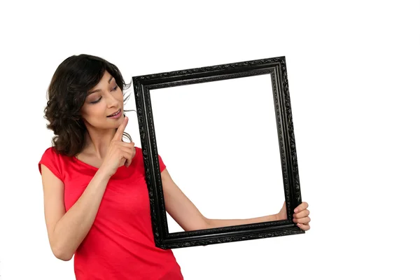 Young woman and a wooden frame — Stock Photo, Image