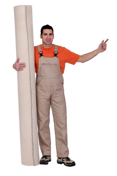 Man with a roll of carpet — Stock Photo, Image
