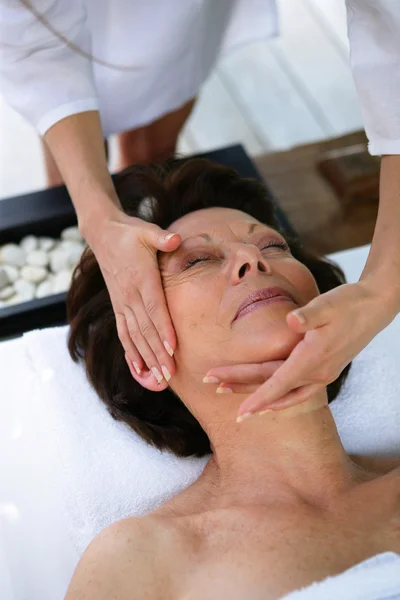 Woman having her face massaged — Stock Photo, Image
