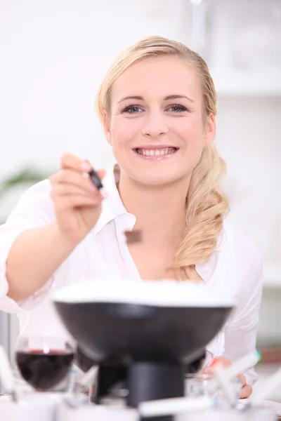 Woman cooking fondue — Stock Photo, Image
