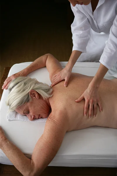 Senior woman having a back massage — Stock Photo, Image