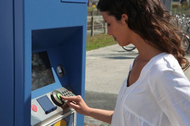 Young woman buying a transport ticket clipart