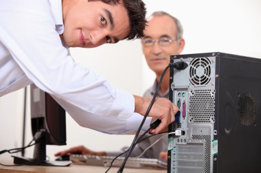 Computer technician repairing PC clipart