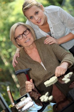 Young woman posing with her grandmother clipart