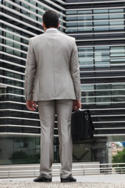 Businessman with gray suit, back view clipart