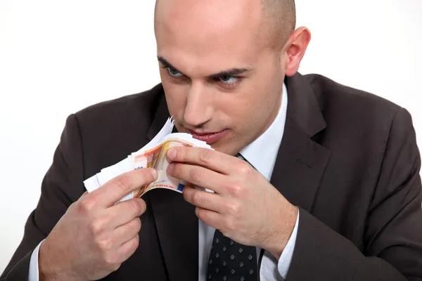 Slecht mens ruiken geld — Stockfoto