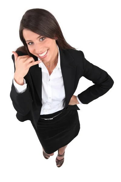 Joven mujer de negocios gesto de teléfono móvil con la mano —  Fotos de Stock