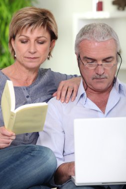 Couple relaxing at home with a book clipart