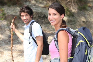 Couple on a mountain hike clipart